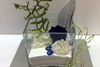 vase carré avec rose bleu et sable blanc
